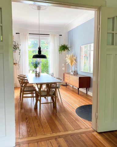 Just passing dining room with long pendant light and table