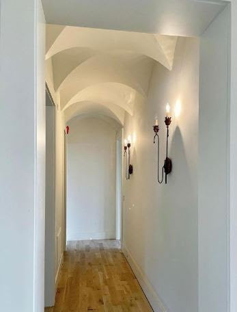 long white hallway with wall lights