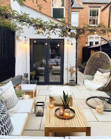 natural cosy outdoor space with seating and hanging lanters