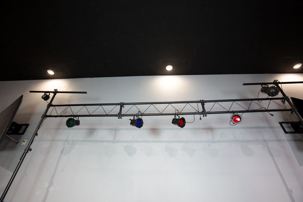 different coloured lights hanging on truss