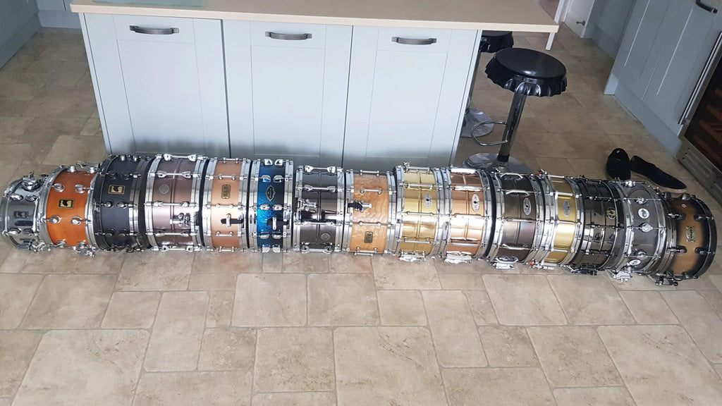 collection of snare drums laid out on the floor