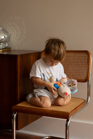 A serene child's bedroom, beautifully lit by a Kiddolab nightlight, symbolizing a peaceful transition to independent sleeping