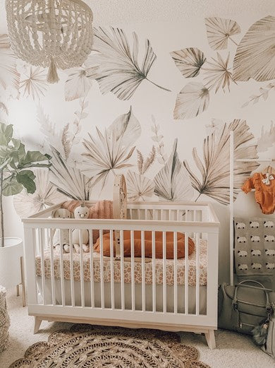 Nursery room with a crib and Bohemian Palms wall decals