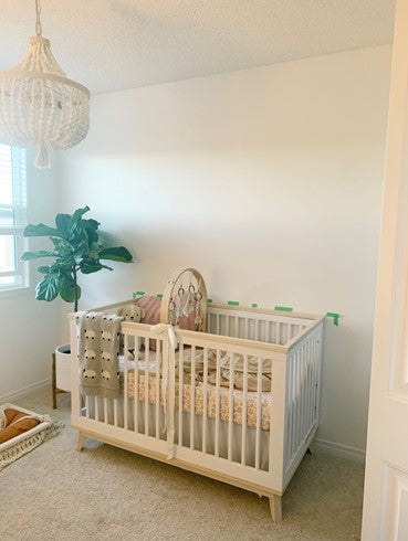 Nursery room with a crib and bare walls