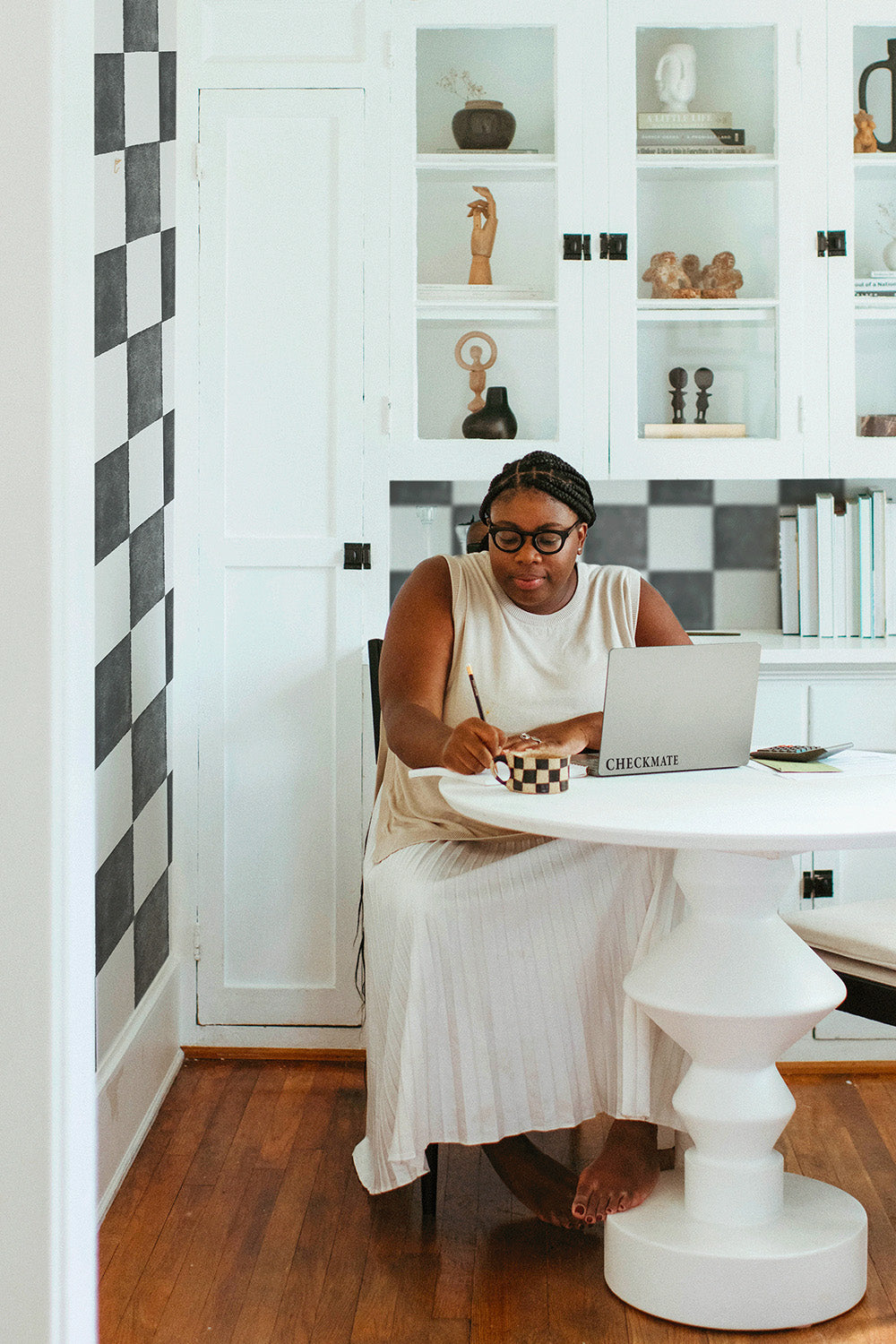 women in retro style black and white checkered kitchen