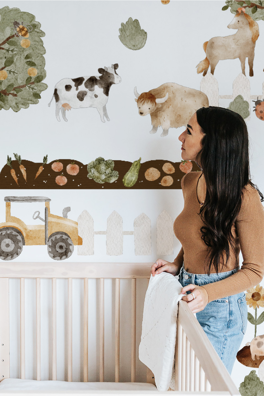 mom decorating baby nursery with farm animal wall decals