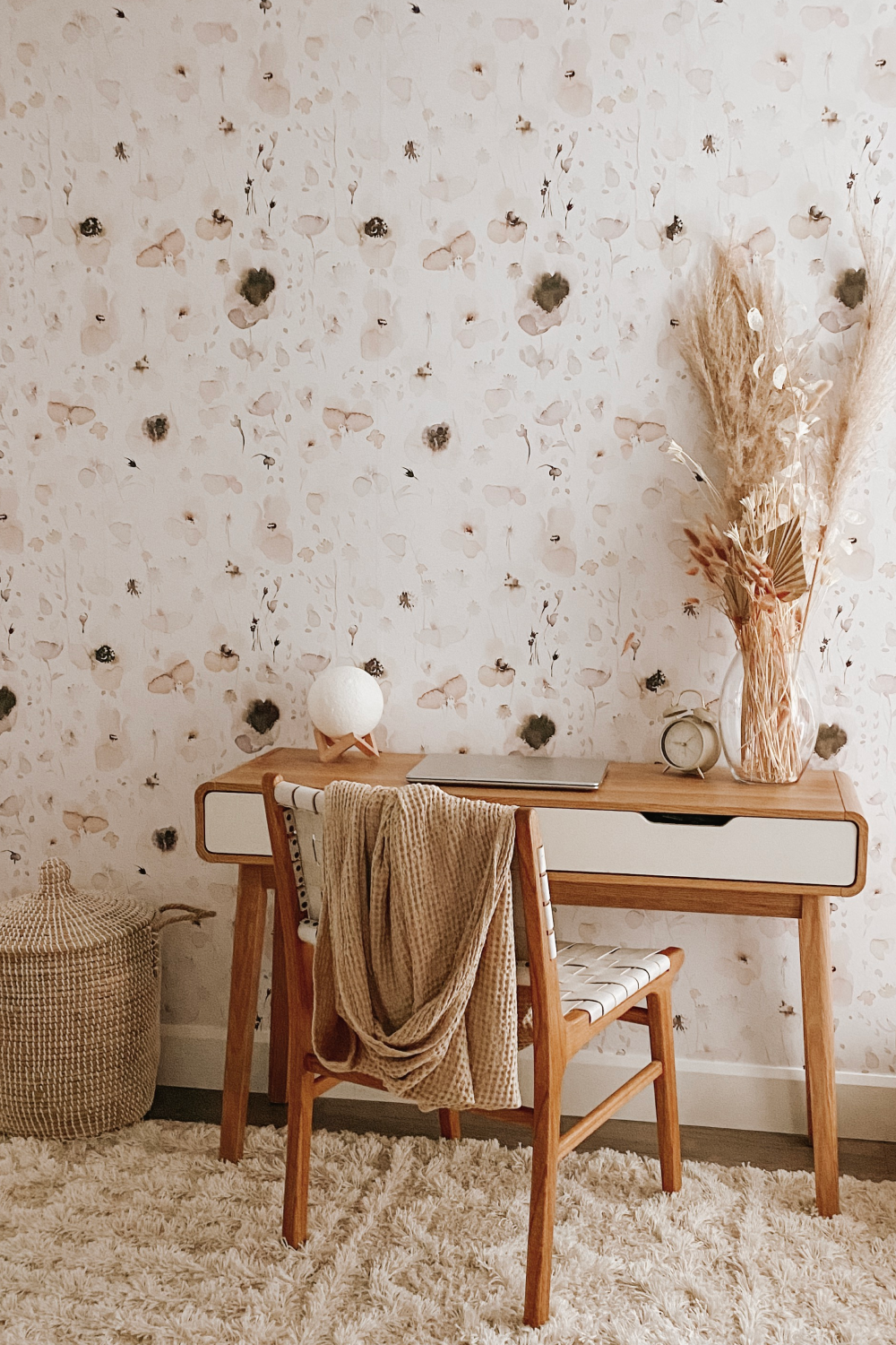 cozy office with wood desk and floral wallpaper