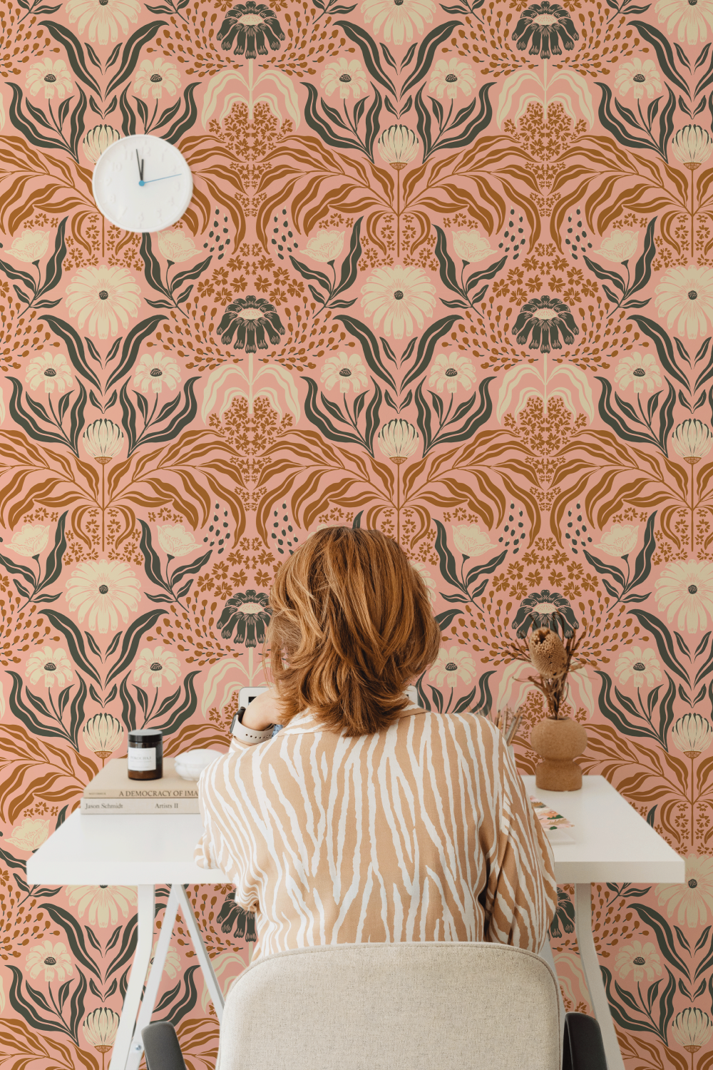 woman at desk with wallpaper on wall