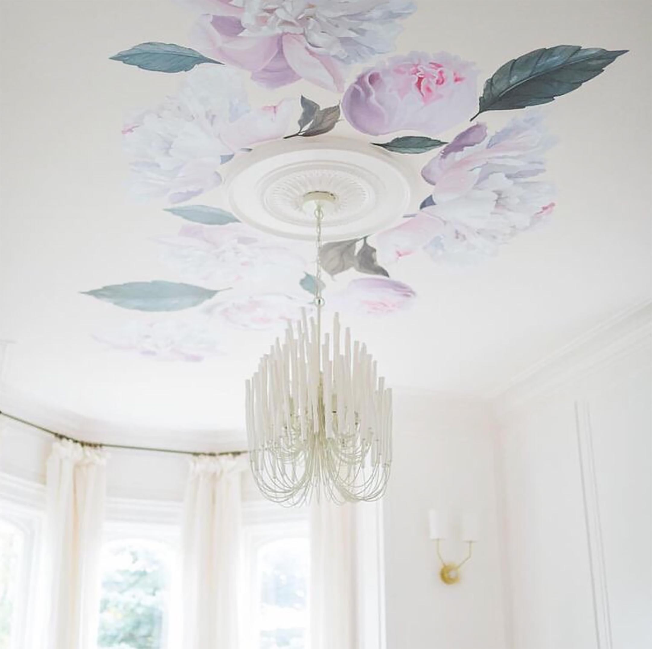 Peonies shown on ceiling surrounding a chandelier.