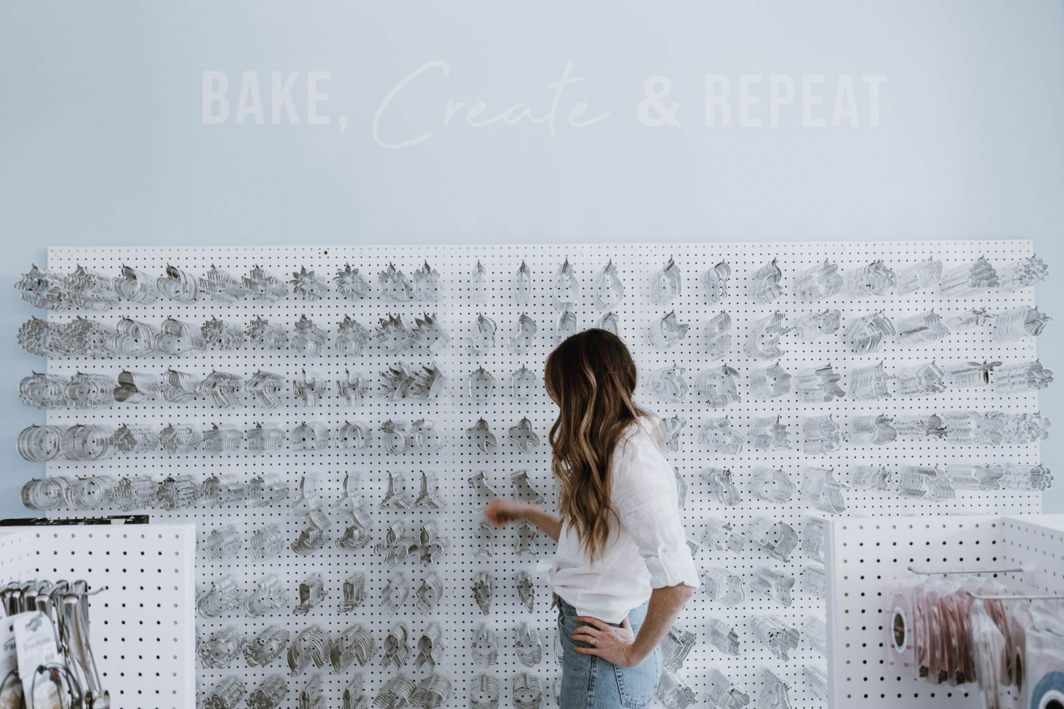 woman standing in front of cookie cutter wall