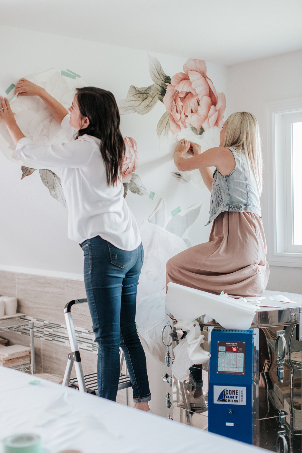 urbanwalls team installing summer daze peonies wall decals