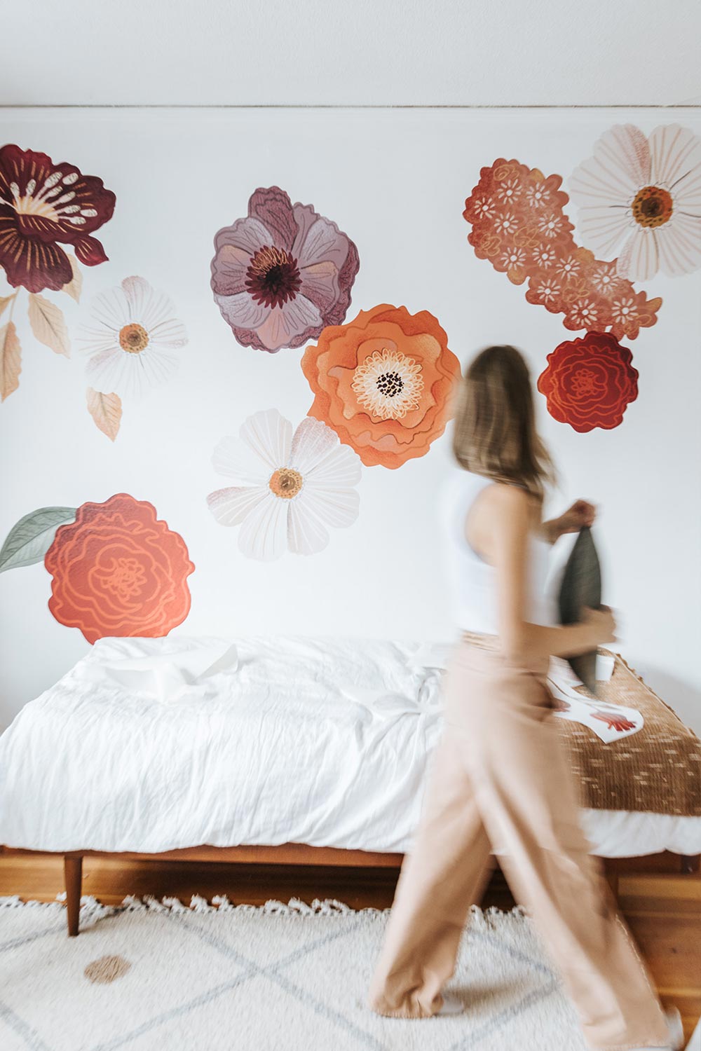 Danielle moving leaf wall decal over to the right side of the room.