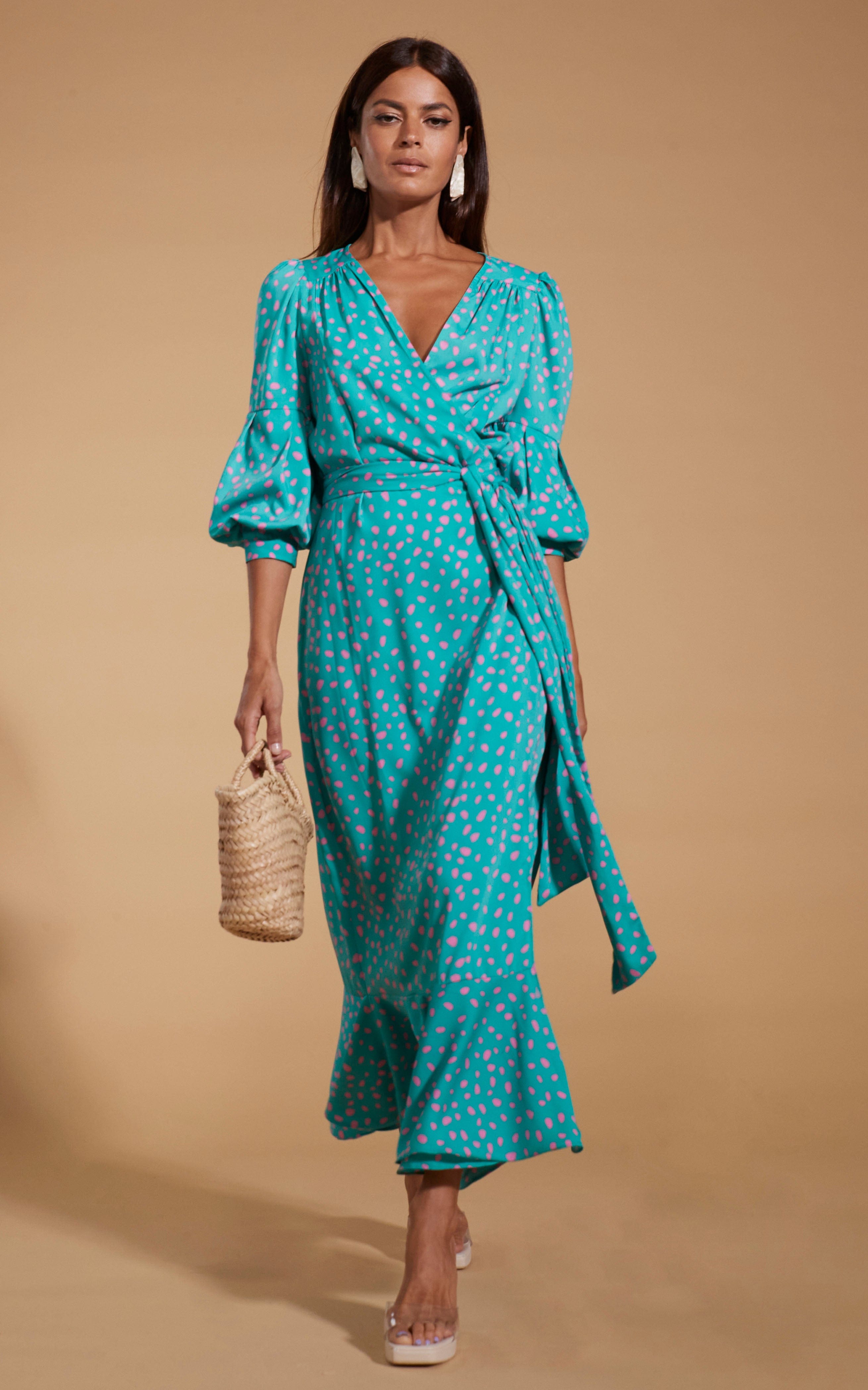 model wearing Havannah Maxi Wrap Dress in Abstract Pink on Sea Green