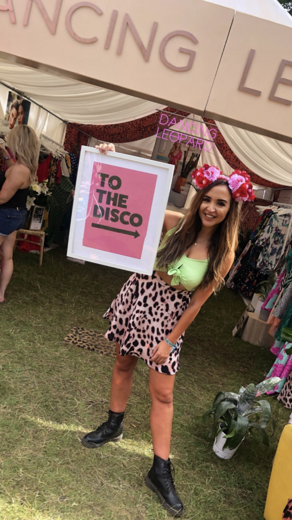 Rosie from Dancing Leopard holding to the disco sign at Boxpark