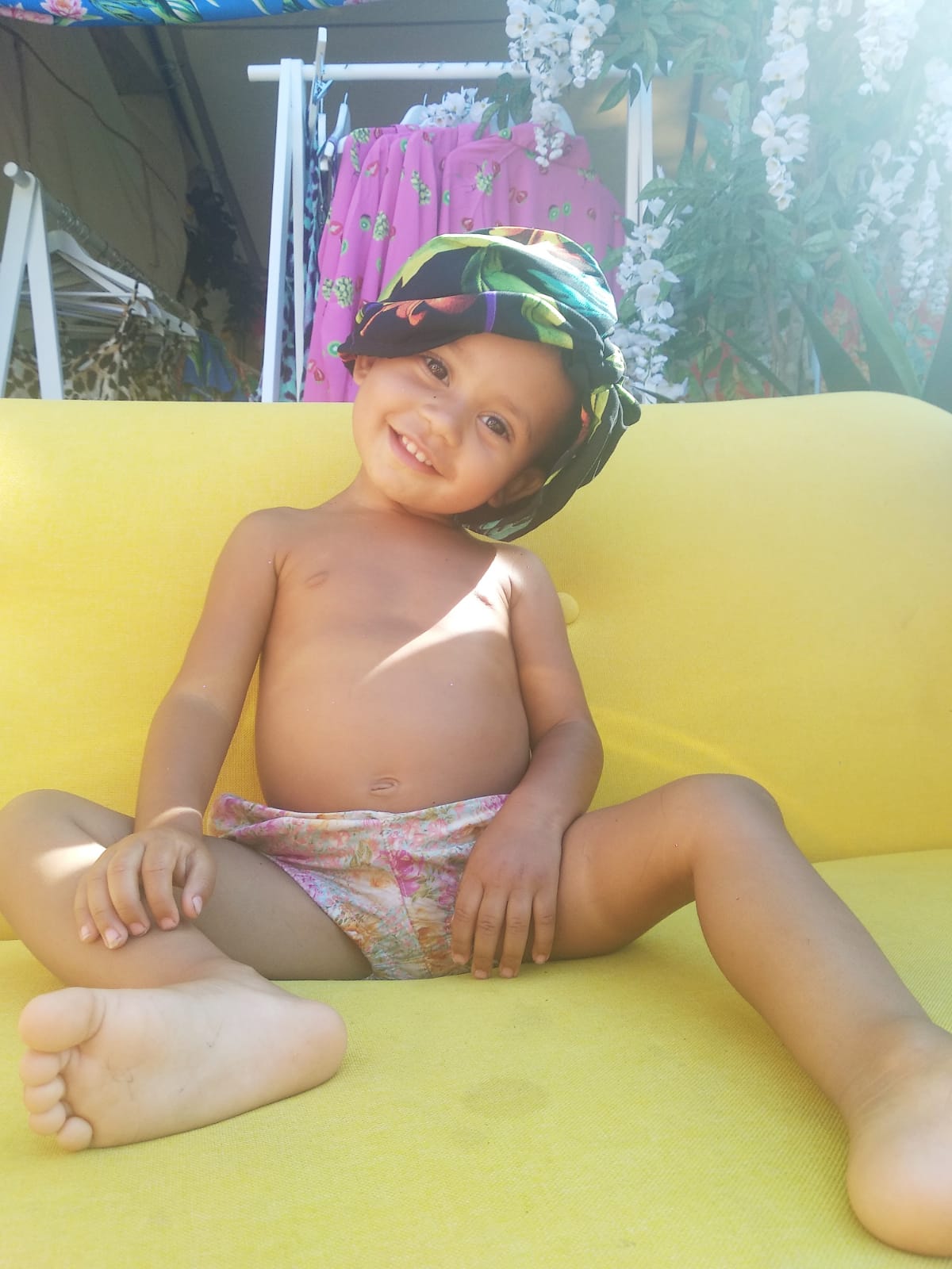 young child using Dancing Leopard clothes as head band