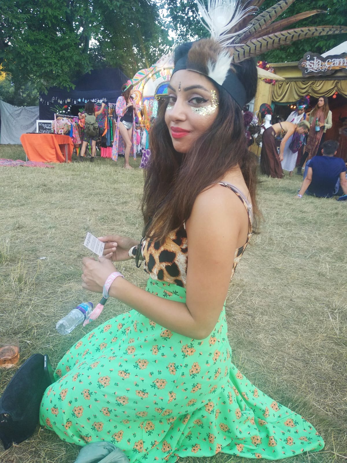 lady wearing Dancing Leopard sat on grass at Wilderness Festival