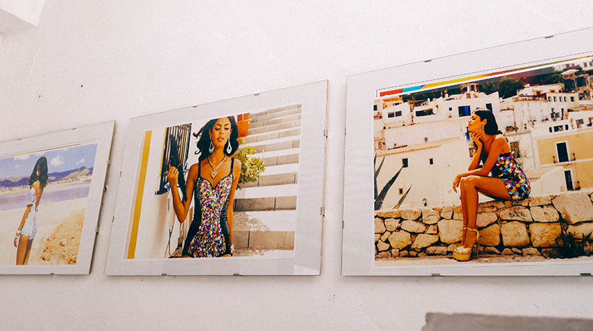 three photos on a wall showing models in different locations in Ibiza