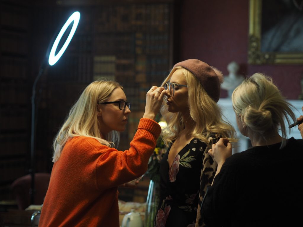 behind the scenes shot on make up artist applying make up to Dancing Leopard model