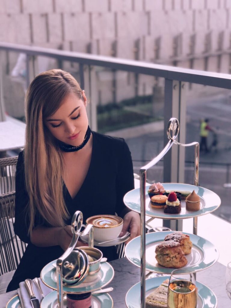 Nelli B with afternoon tea wearing Zeina Wrap Mini in Black