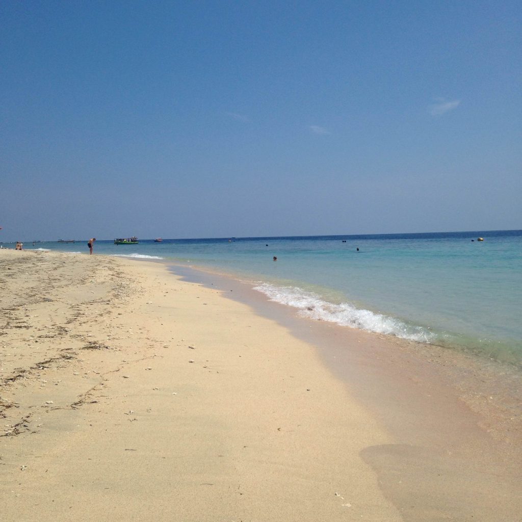 beach in Bali with boat in the background