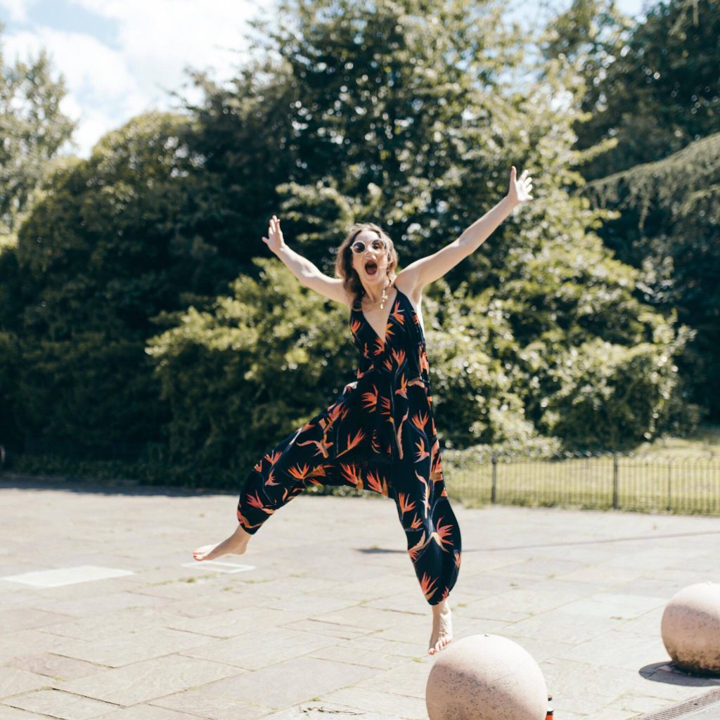 Jody Shield jumping whilst wearing a Dancing Leopard jumpsuit