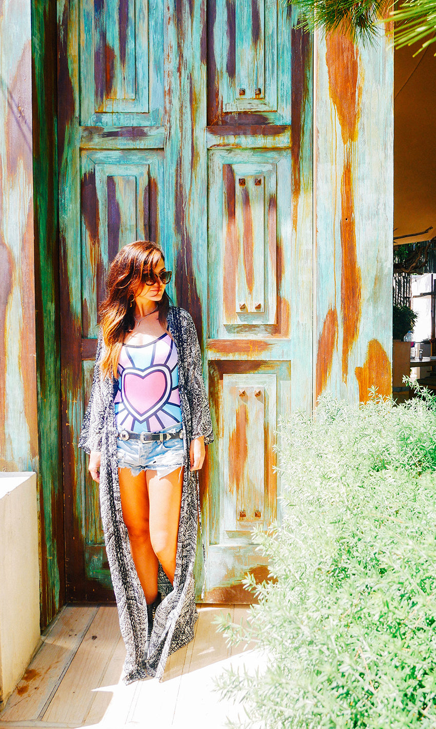Kate Marron stood in front of an old green painted wooden door