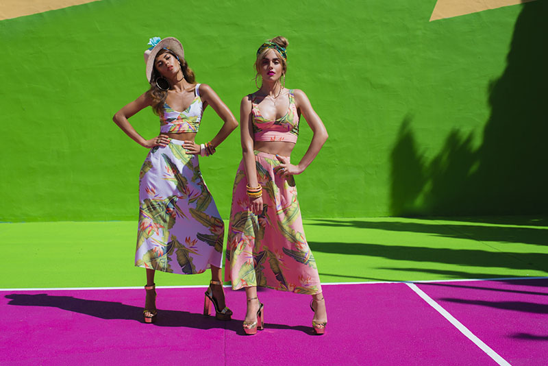 Dancing Leopard models stood on bright purple and green tennis court