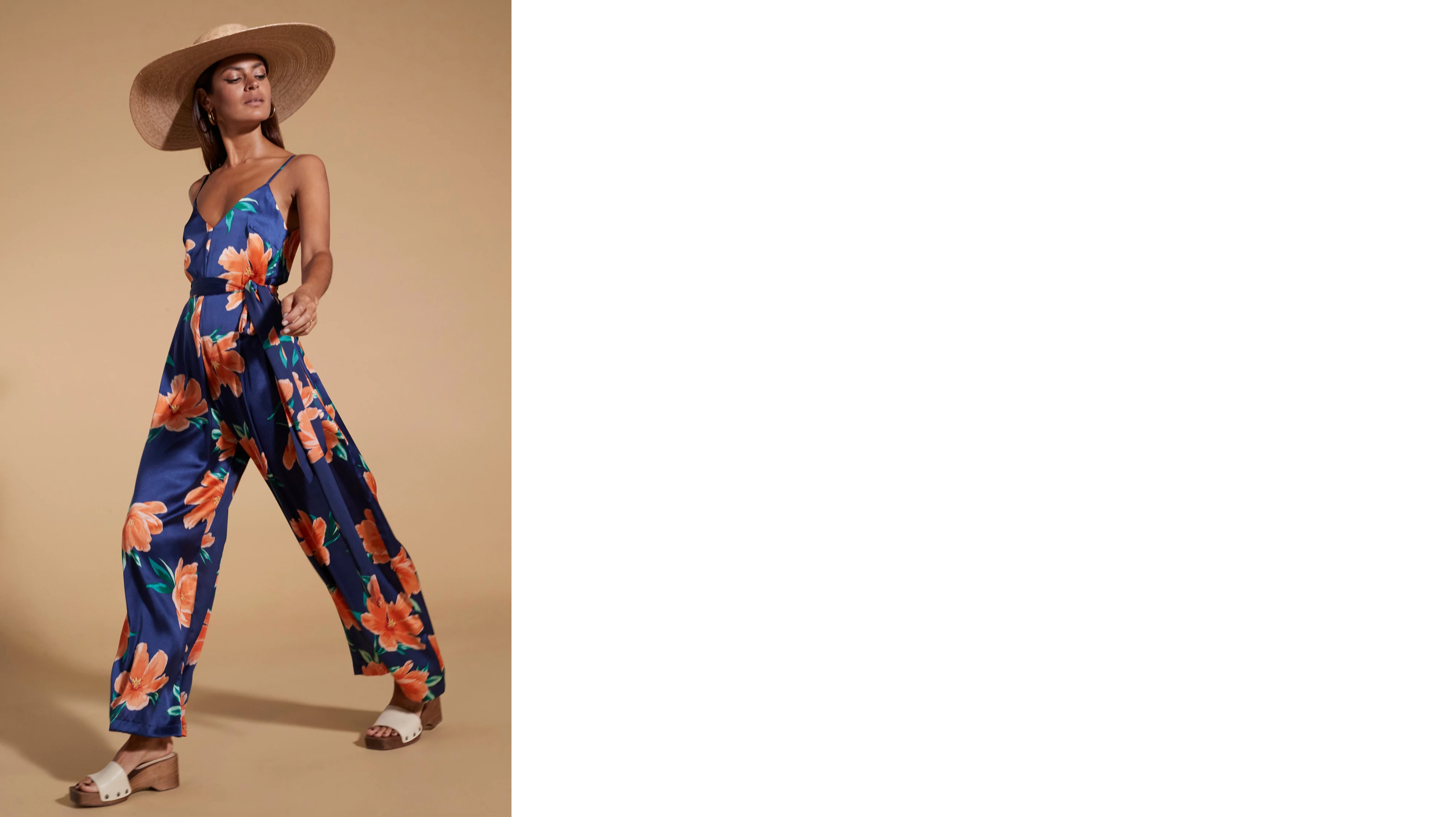 model wearing Gabriella Jumpsuit in Orange on Navy Blue Tulip