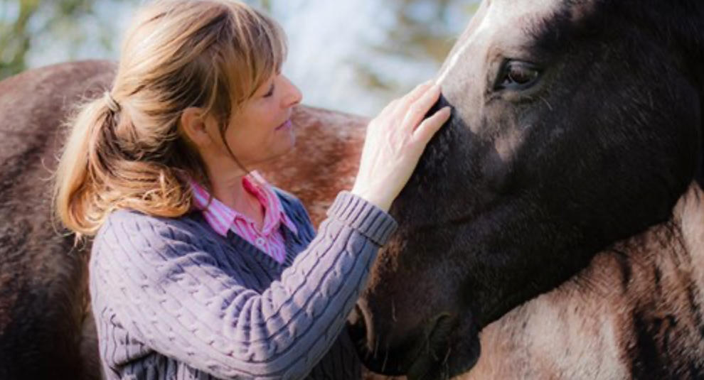 Lynn Henry petting a horse