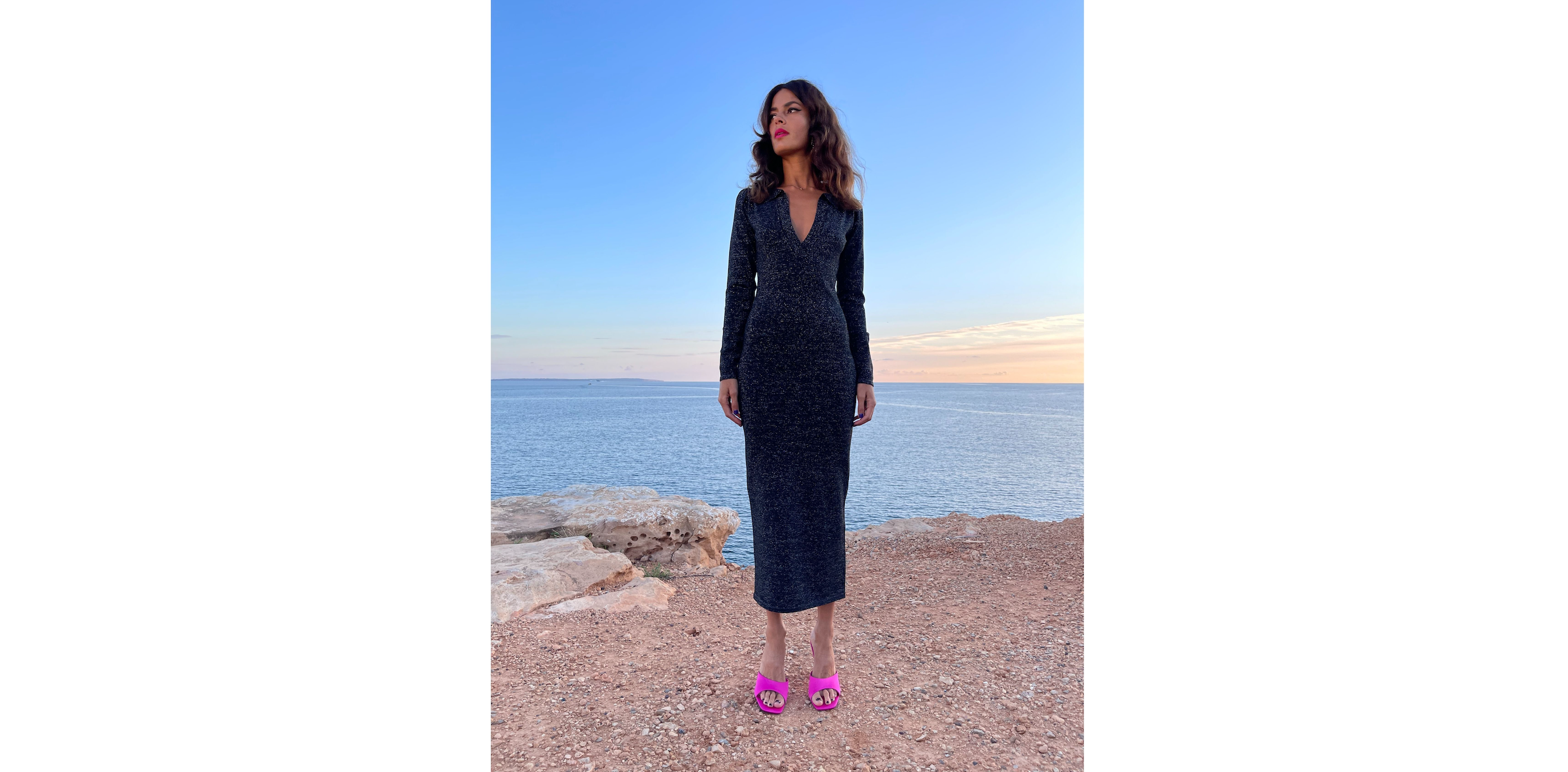 Dancing Leopard model wearing black sparkly maxi dress stood beside the sea