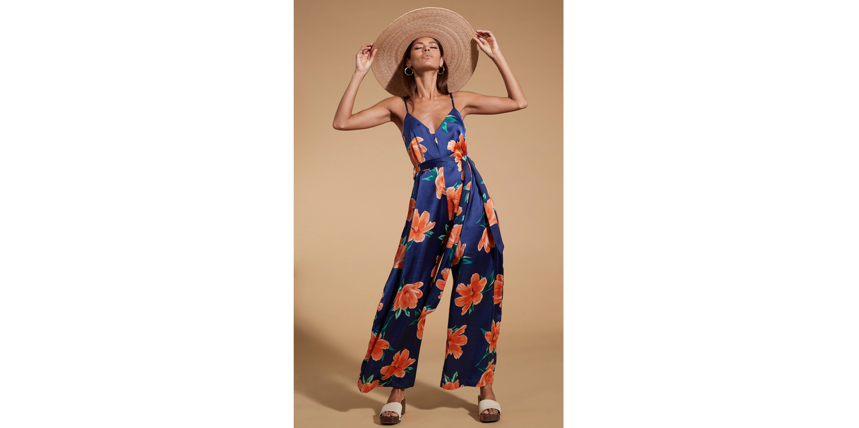 model wearing Gabriella Jumpsuit In Orange On Navy Blue Tulip