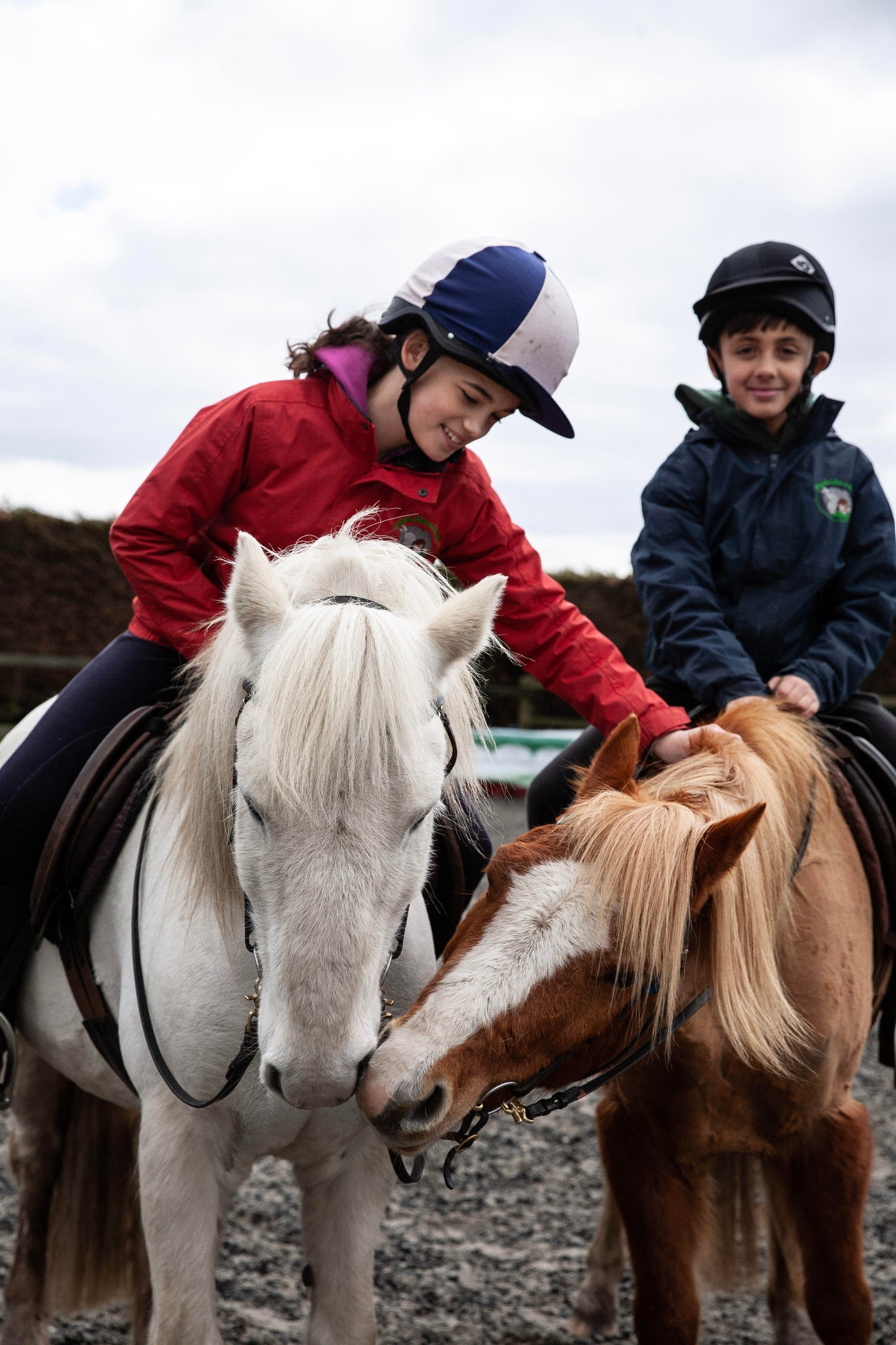 2 young children sat on ponies