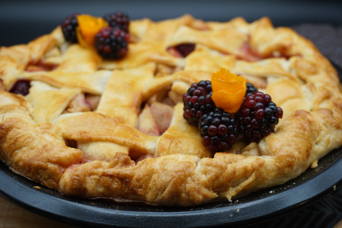 Seasonal apple and blackberry pie low angle