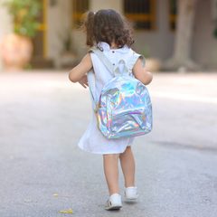 Image of a young girl wearing a holographic backpack