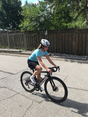 Woman biking comfortably in Brubeck padded bike shorts.