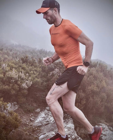 Man running up mountain trail