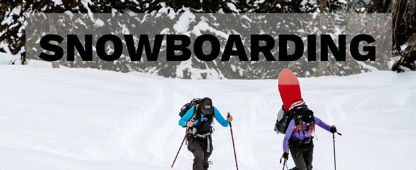 Women hiking in snow backcountry with boards on back. Snowboarding Collection Reccomendations