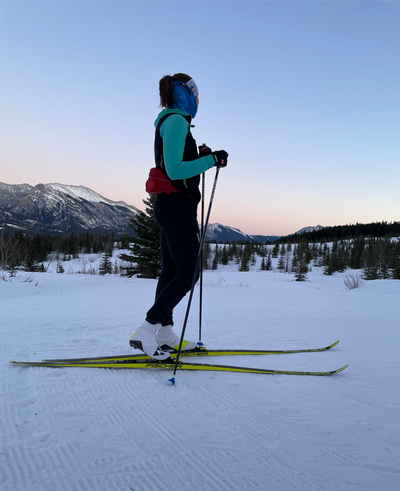 Woman Nordic Skiing at sunset in Mountains  
