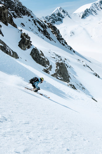 Woman backcountry downhill skiing 