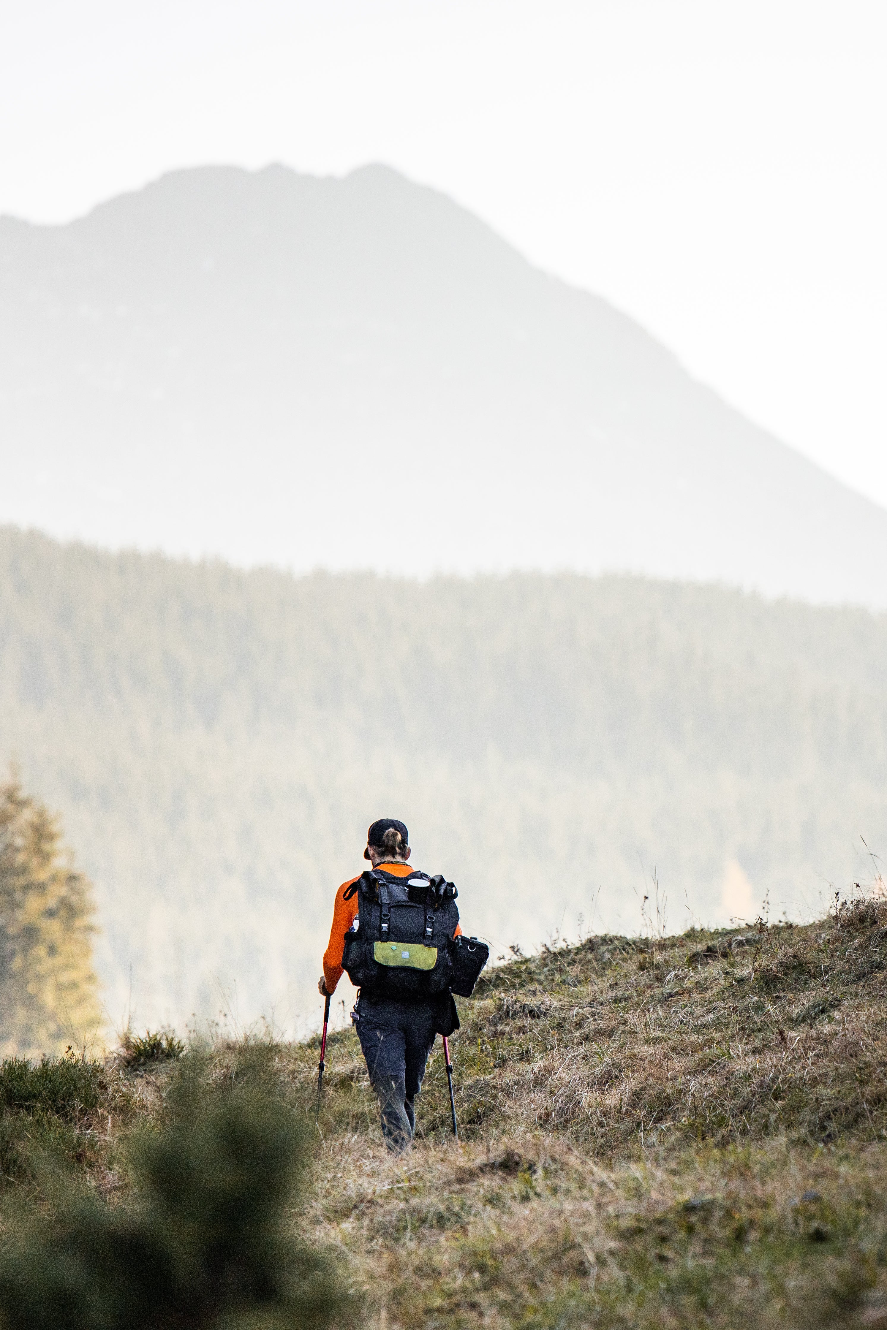 Man hiking in valley with pack on