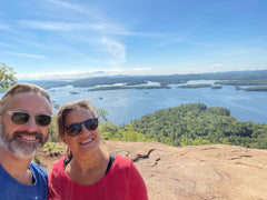 man, woman, overlooking lakes on mountain top