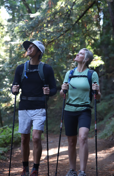 couple hiking in the woods in sun protective clothing