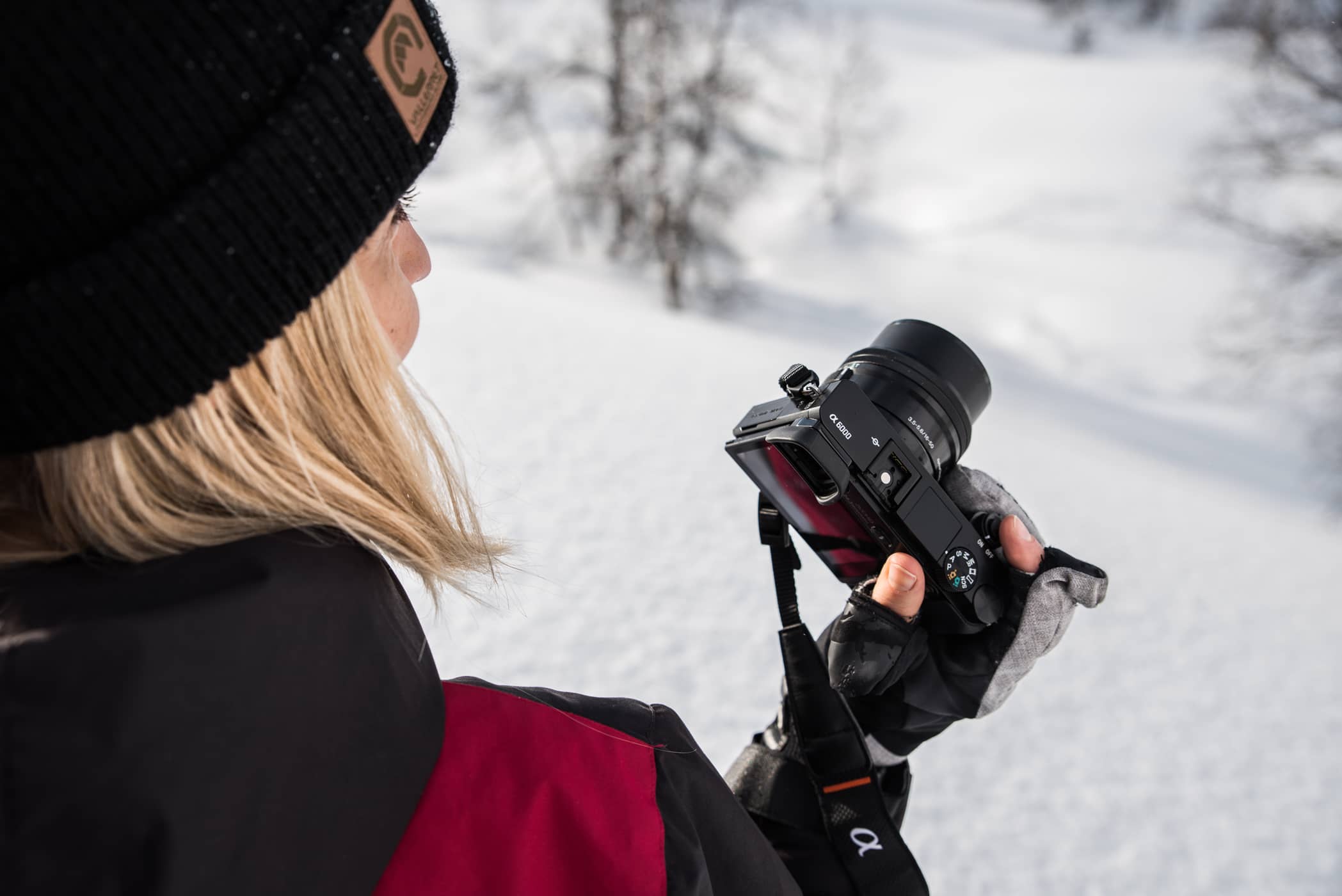 woman wearing gloves taking a photo