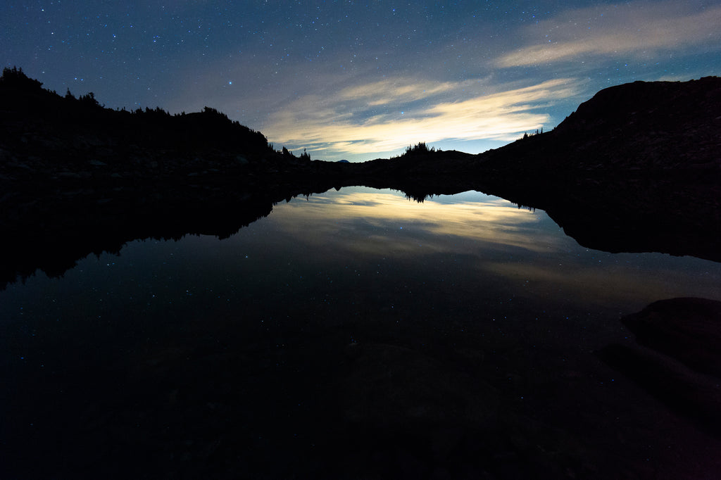 Night photography of stars over a lake