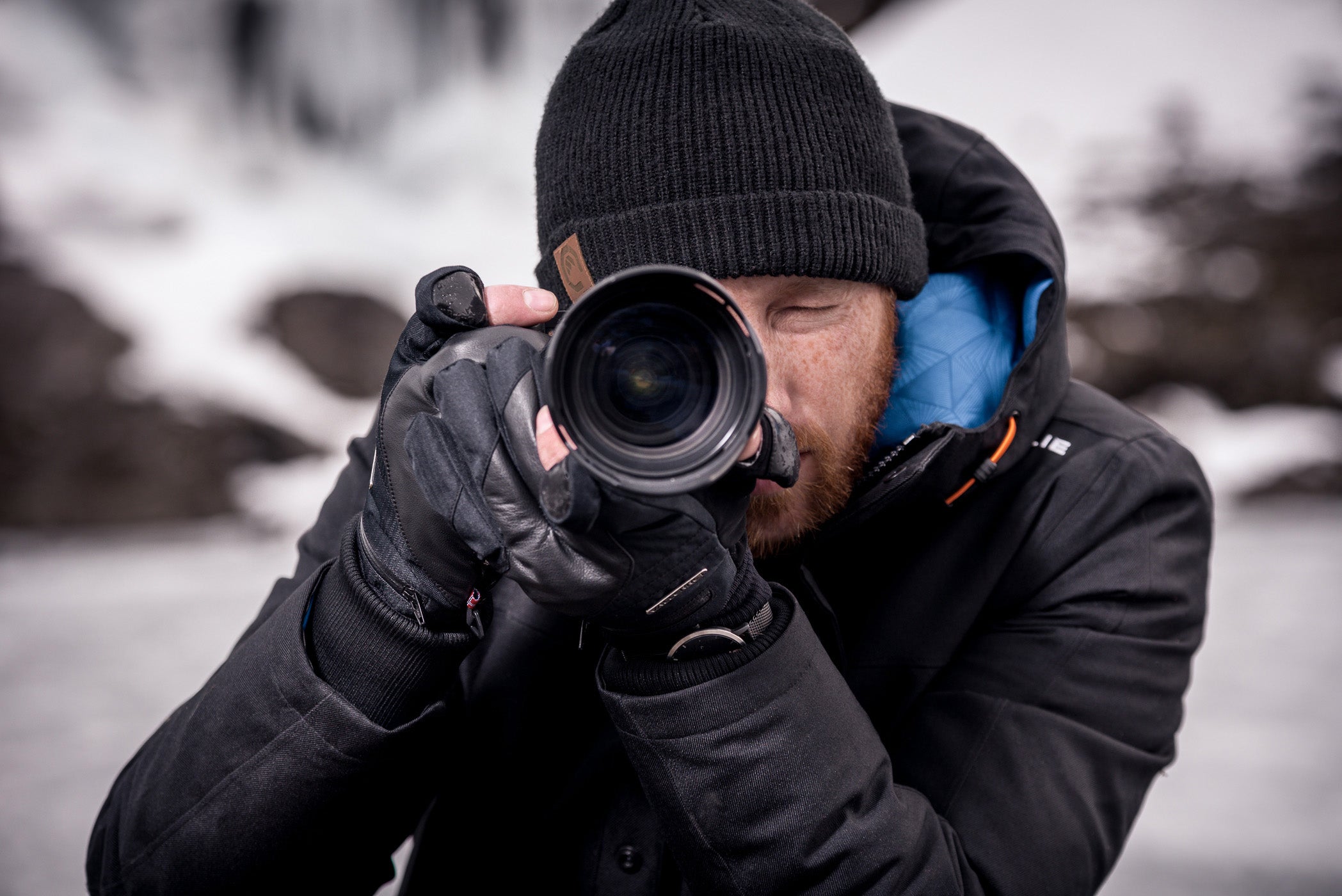 man taking a photo in the snow