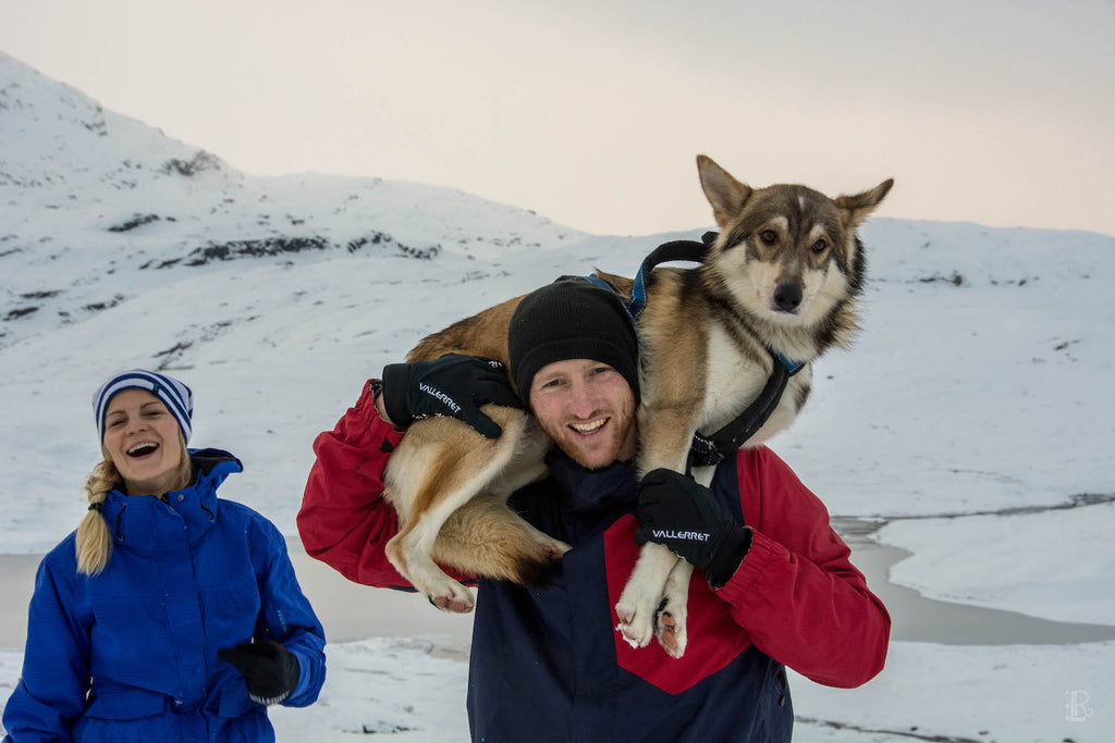 laughing with a dog in the snow