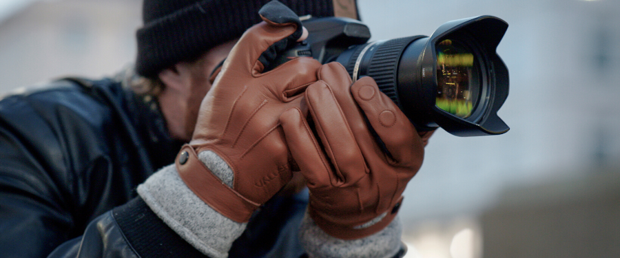 photographer with gloves on shooting in an urban setting
