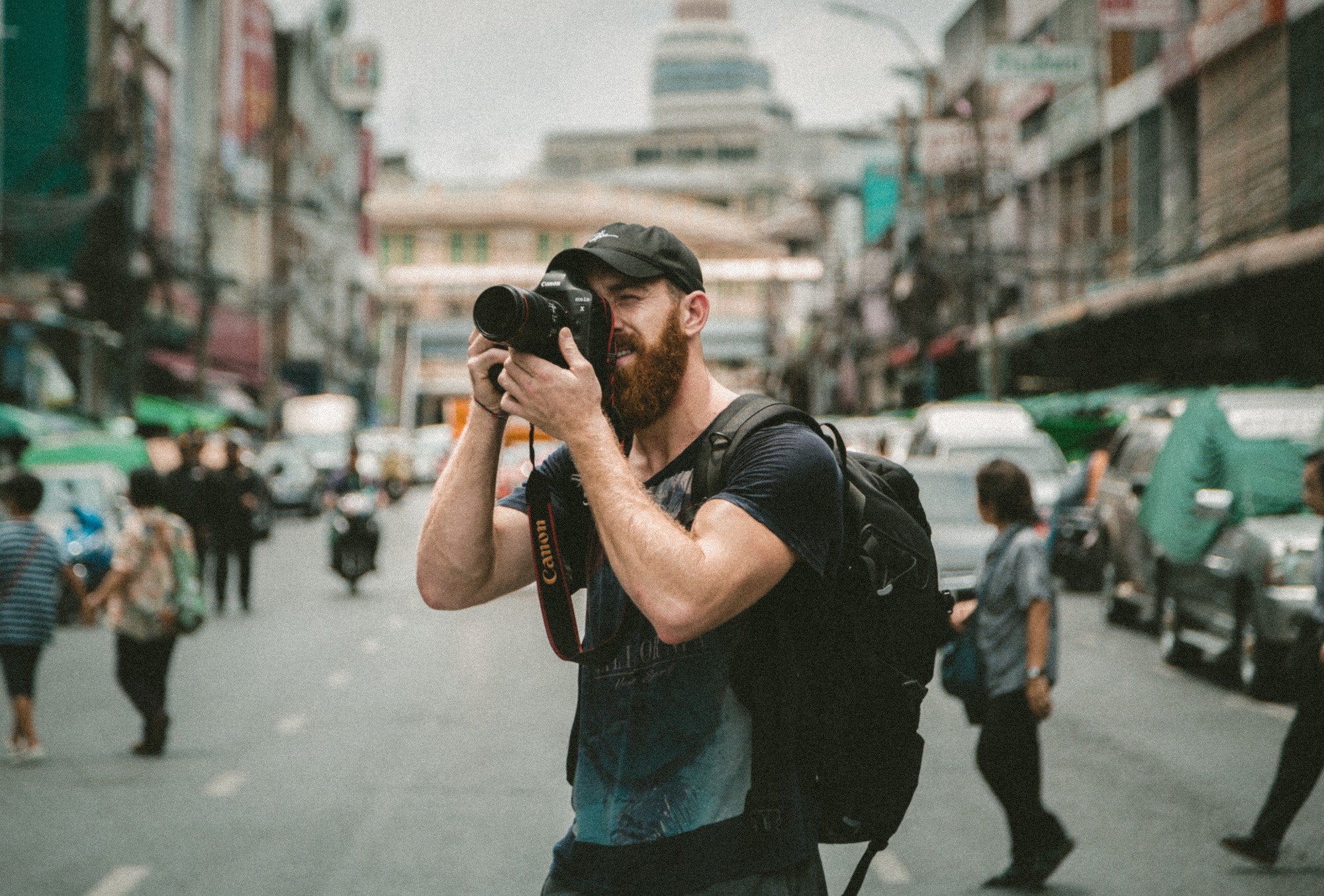 man taking a photo in an urban area