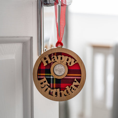 Hanging lucky sixpence with the words happy birthday.