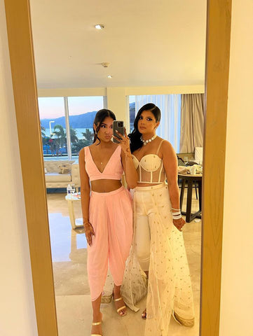 sister duo ready for welcome dinner in Queen skirant set and Blush pink dhoti set